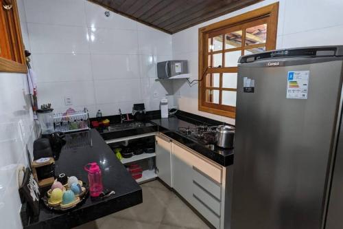 a kitchen with a refrigerator and a counter top at Casa histórica do escravo isidoro in Diamantina