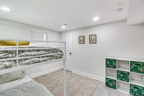 a bedroom with white walls and white shelves at Lower-Level Apartment in District Heights Near DC! in District Heights