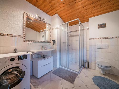 a bathroom with a washing machine and a shower at Strasshof in Stuhlfelden