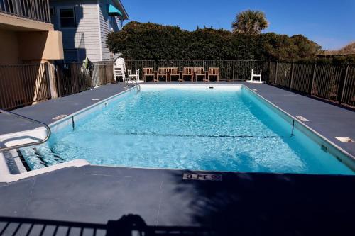 a small swimming pool with blue water in a house at Casa Al Mare in Carolina Beach