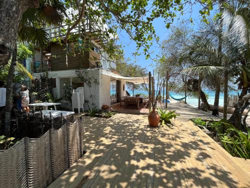 a house with a wooden walkway next to the ocean at Casa Tinti Hotel Boutique in Tintipan Island