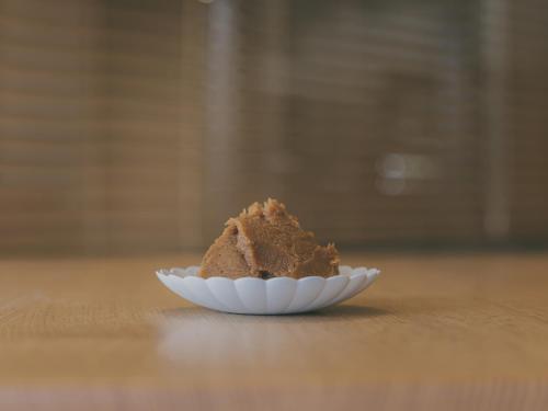 a white plate of brown powder on a table at Chalet Shiga in Yamanouchi
