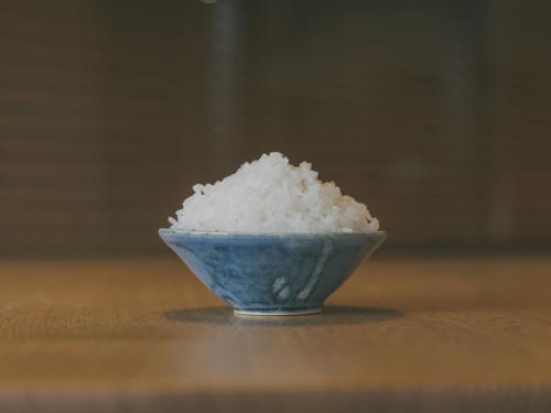 a blue bowl of rice sitting on a table at Chalet Shiga in Yamanouchi