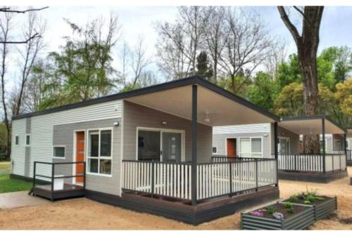 a tiny house is shown with a porch at Discovery Parks - Bright in Bright