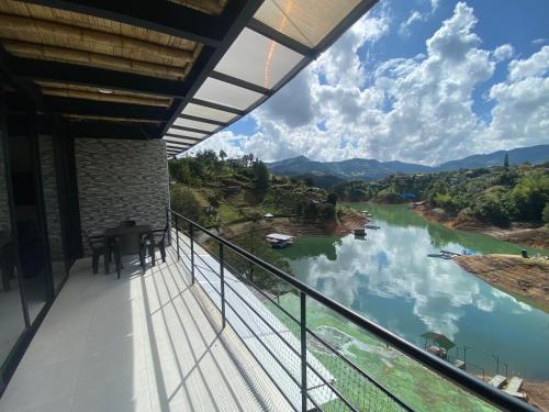 a balcony with a view of a river at Springfield Ecoloft- Guatapé in Guatapé
