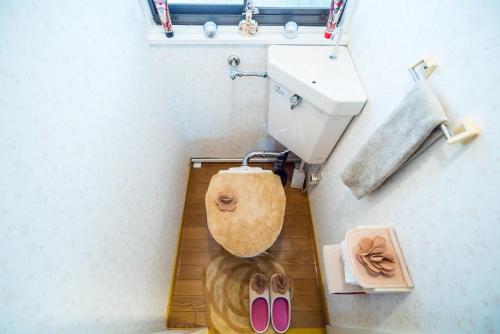a bathroom with a toilet and a sink and some shoes at Murata COPO 305 / Vacation STAY 2893 in Tokyo