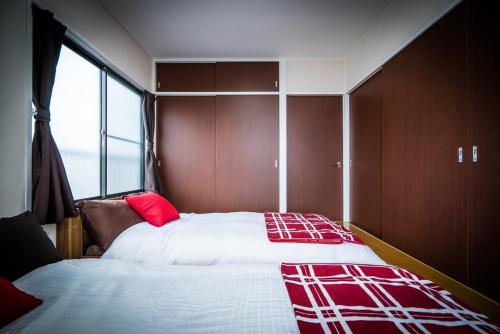a bedroom with two beds and a large window at Murata COPO 305 / Vacation STAY 2893 in Tokyo