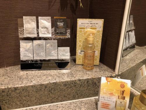 a counter top with a bottle of soap and a mirror at HOTEL Sweets in Mobara