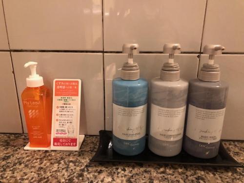 a group of four bottles of detergent on a shelf at HOTEL Sweets in Mobara