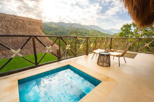 a swimming pool on a balcony with a view at Hotel Alto de Pajas Boutique by H&R in Villeta