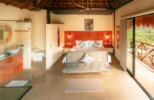 a bedroom with a bed and a sink and a toilet at Hotel Alto de Pajas Boutique by H&R in Villeta