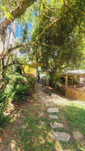 a path in a park with trees and a person walking down it at Hospedajes Richie Eco Camp in Providencia