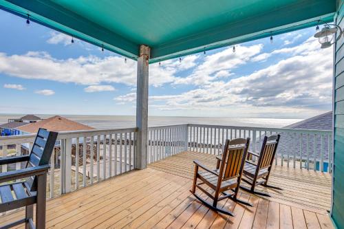 a deck with two chairs and a view of the ocean at Footprints in the Sand - Luxe Freeport Home! in Freeport