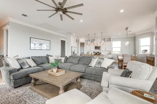 a living room with a couch and a table at Footprints in the Sand - Luxe Freeport Home! in Freeport