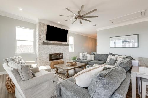a living room with a couch and a fireplace at Footprints in the Sand - Luxe Freeport Home! in Freeport
