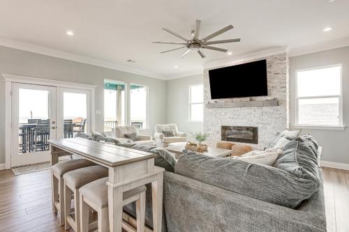 a living room with a couch and a fireplace at Footprints in the Sand - Luxe Freeport Home! in Freeport