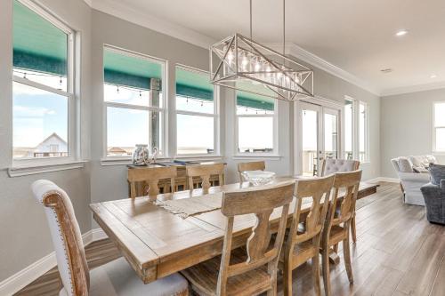 a dining room and living room with a table and chairs at Footprints in the Sand - Luxe Freeport Home! in Freeport