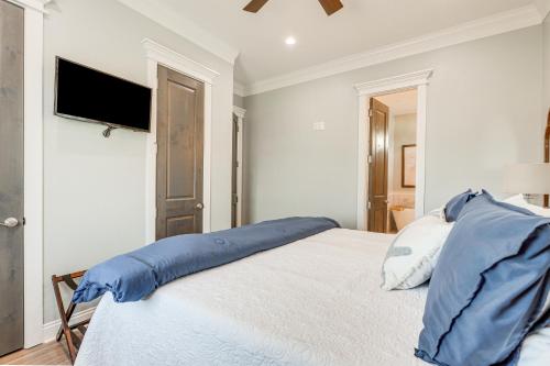 a bedroom with a bed with a blue pillow on it at Footprints in the Sand - Luxe Freeport Home! in Freeport