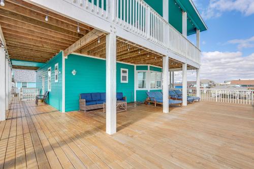 a blue house with a deck with benches on it at Footprints in the Sand - Luxe Freeport Home! in Freeport