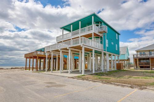 a building on the beach with a blue at Footprints in the Sand - Luxe Freeport Home! in Freeport