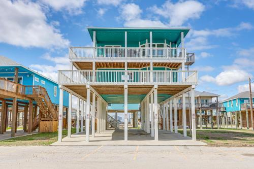 a building with a balcony on top of it at Footprints in the Sand - Luxe Freeport Home! in Freeport