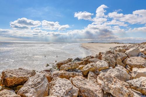 a group of rocks on a beach near the ocean at Footprints in the Sand - Luxe Freeport Home! in Freeport