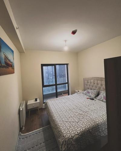 een slaapkamer met een bed en een raam bij REZİDANS in Istanbul