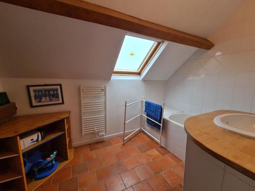 a bathroom with a sink and a tub and a window at Ferme rénovée au calme avec internet et grand espace extérieur - FR-1-591-149 in Palluau-sur-Indre