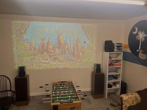a room with a large mural on the wall at Elegant Huge Ocean View 4 King, Private Pool, Huge Yard, Enormous Game Garage, BBQ, & Rooftop Deck in Myrtle Beach