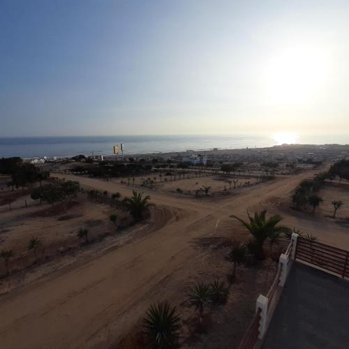 a view of a dirt road next to the ocean at CASA DE PLAYA Durante todo el año in Punta Negra