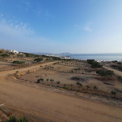 an aerial view of a dirt road next to the ocean at CASA DE PLAYA Durante todo el año in Punta Negra