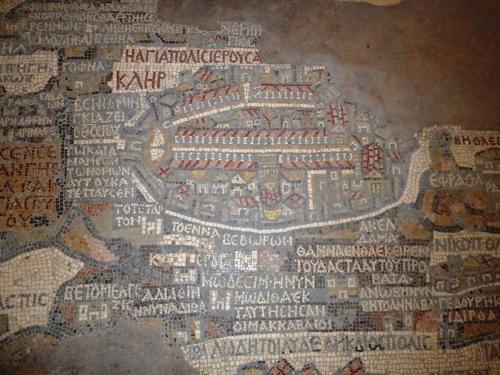 a mosaic of a city in the floor of a building at Pilgrim's Guest House in Madaba