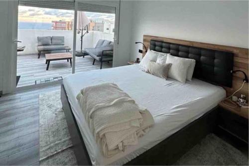 um quarto com uma cama grande e uma sala de estar em Luxury penthouse em Santa Cruz de Tenerife