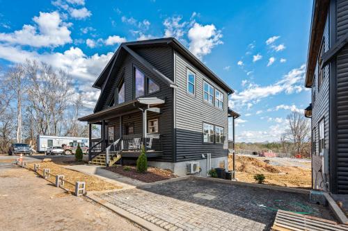 a home under construction with a black house at SmokiesBoutiqueCabins would love to host you at our NEW cabin! 3 King Suites, Indoor Pool, Game Room, Lounge with 75" TV! Close to Dollywood and the Parkway! in Pigeon Forge