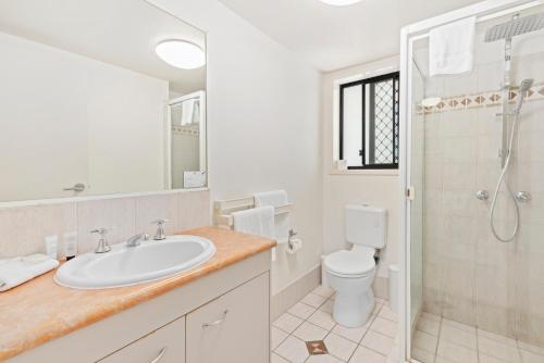 a bathroom with a sink and a shower and a toilet at Island Beach Resort in Gold Coast