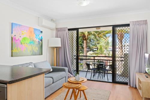 a living room with a couch and a table at Island Beach Resort in Gold Coast