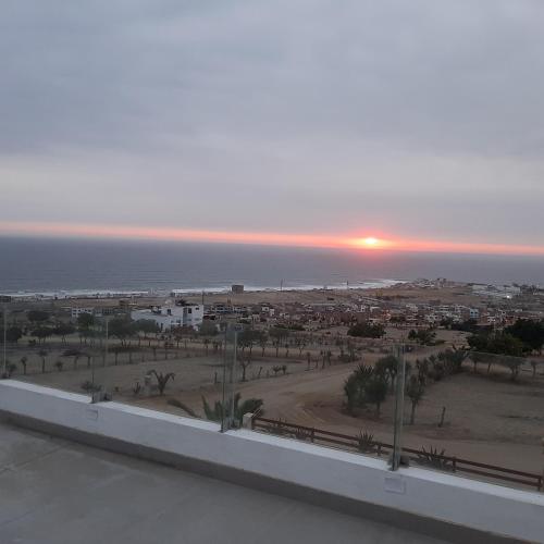 a view of a city with the sunset in the background at CASA DE PLAYA Durante todo el año in Punta Negra