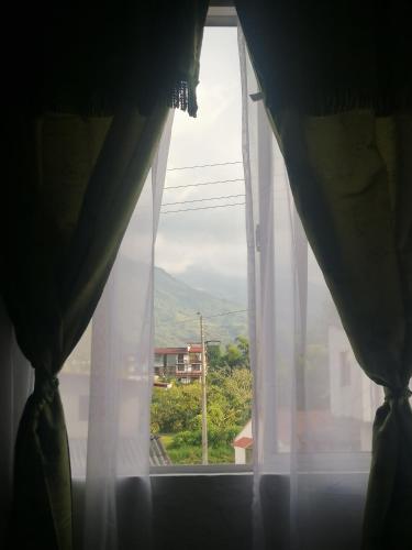 a window with a view of a mountain at Apartaestudios La Baranda in Salento