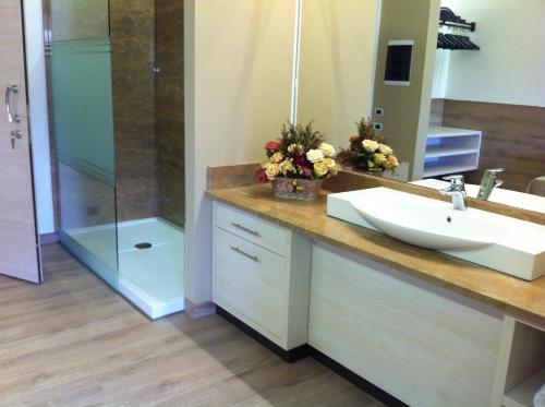 a bathroom with a sink and a shower at Luna Residence Hotel in Casalmaggiore