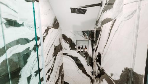 a bathroom with a shower with a mountain mural at Private Modern Luxury Suite in Historic Stone Home in Washington