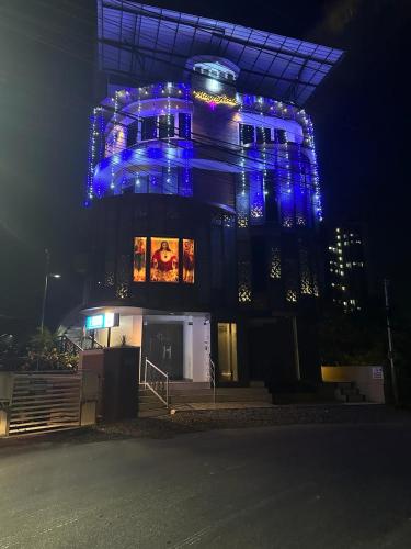 a building with blue lights on it at night at Magni Home in Cochin