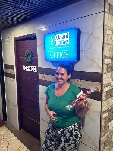 a woman is standing in front of a office at Magni Home in Cochin
