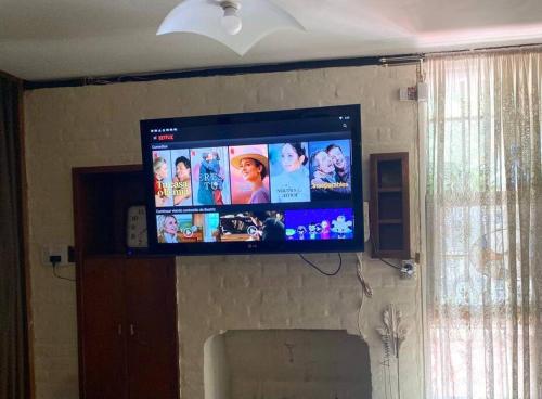 a flat screen television hanging on a wall at Casa Tupungato con Churrasquera in Tupungato