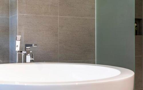 a bathroom with a white sink and a mirror at The Line Hotel in Yangpyeong