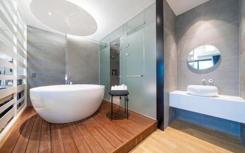 a bathroom with a large white tub and a sink at The Line Hotel in Yangpyeong