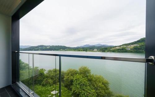 a view of a lake from a balcony at The Line Hotel in Yangpyeong