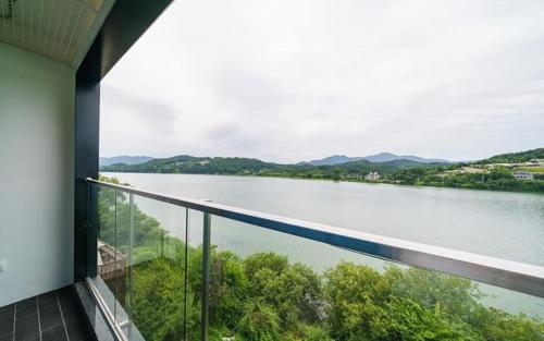 a view of a river from a balcony of a house at The Line Hotel in Yangpyeong