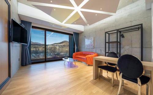 a living room with a couch and a table at The Line Hotel in Yangpyeong
