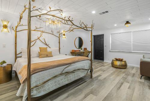 a bedroom with a bed with a tree branch on it at Candlewick Inn and Suites in Eureka Springs
