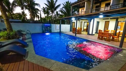 a swimming pool in the backyard of a house at Bakasyunan Resort and Conference Center - Zambales in Iba